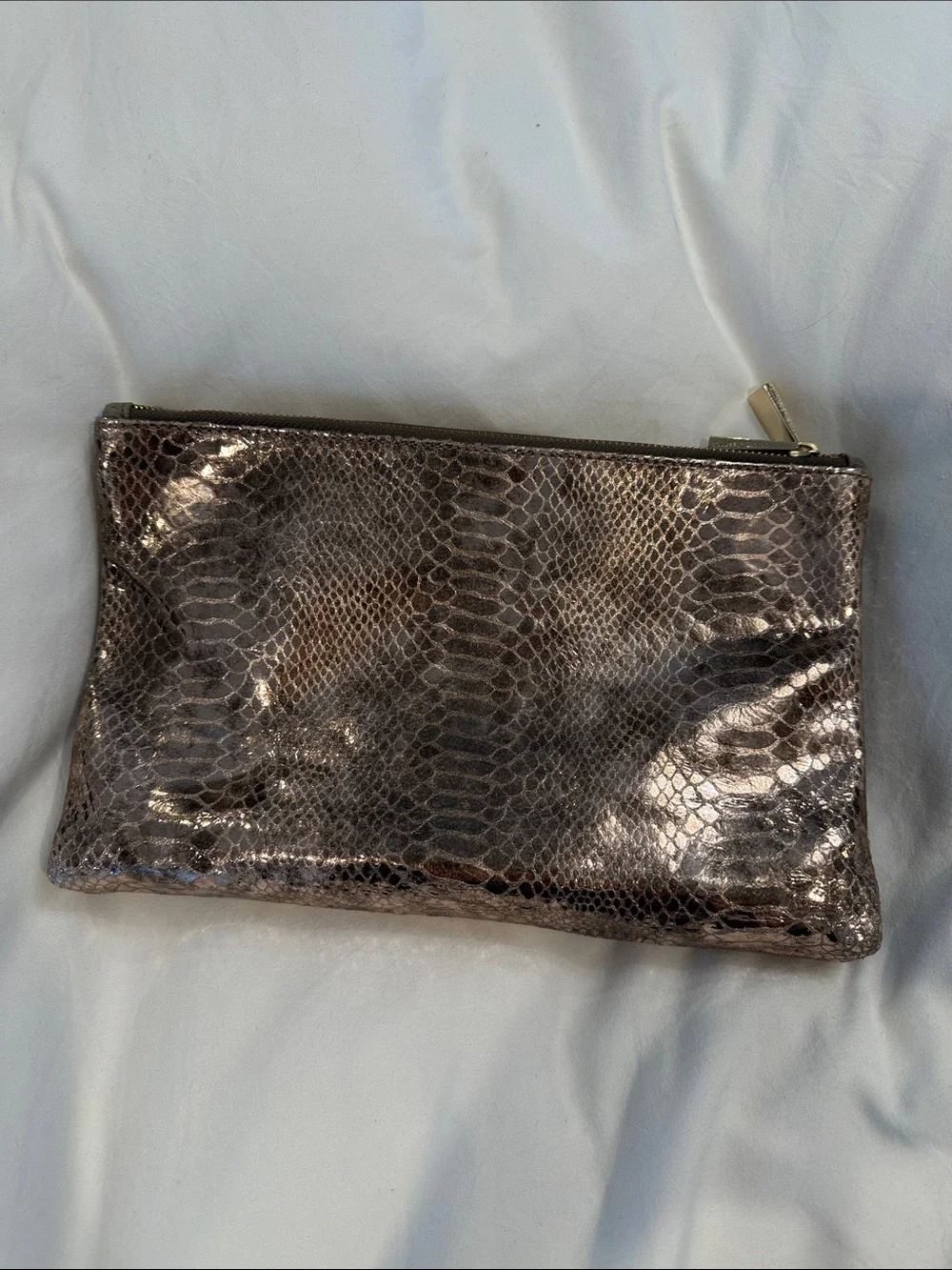 Leather Zip reversible clutch in Metallic taupe and reverses to rose gold